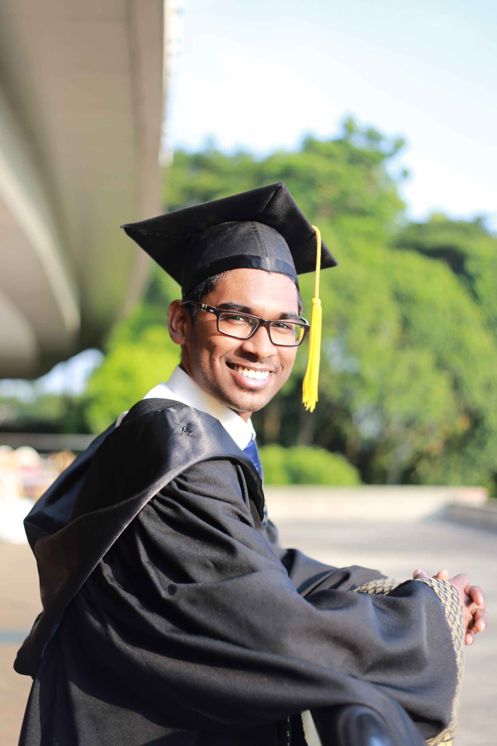 A young man in a cap and gown has educational dreams realized by Kids Chance scholarship.